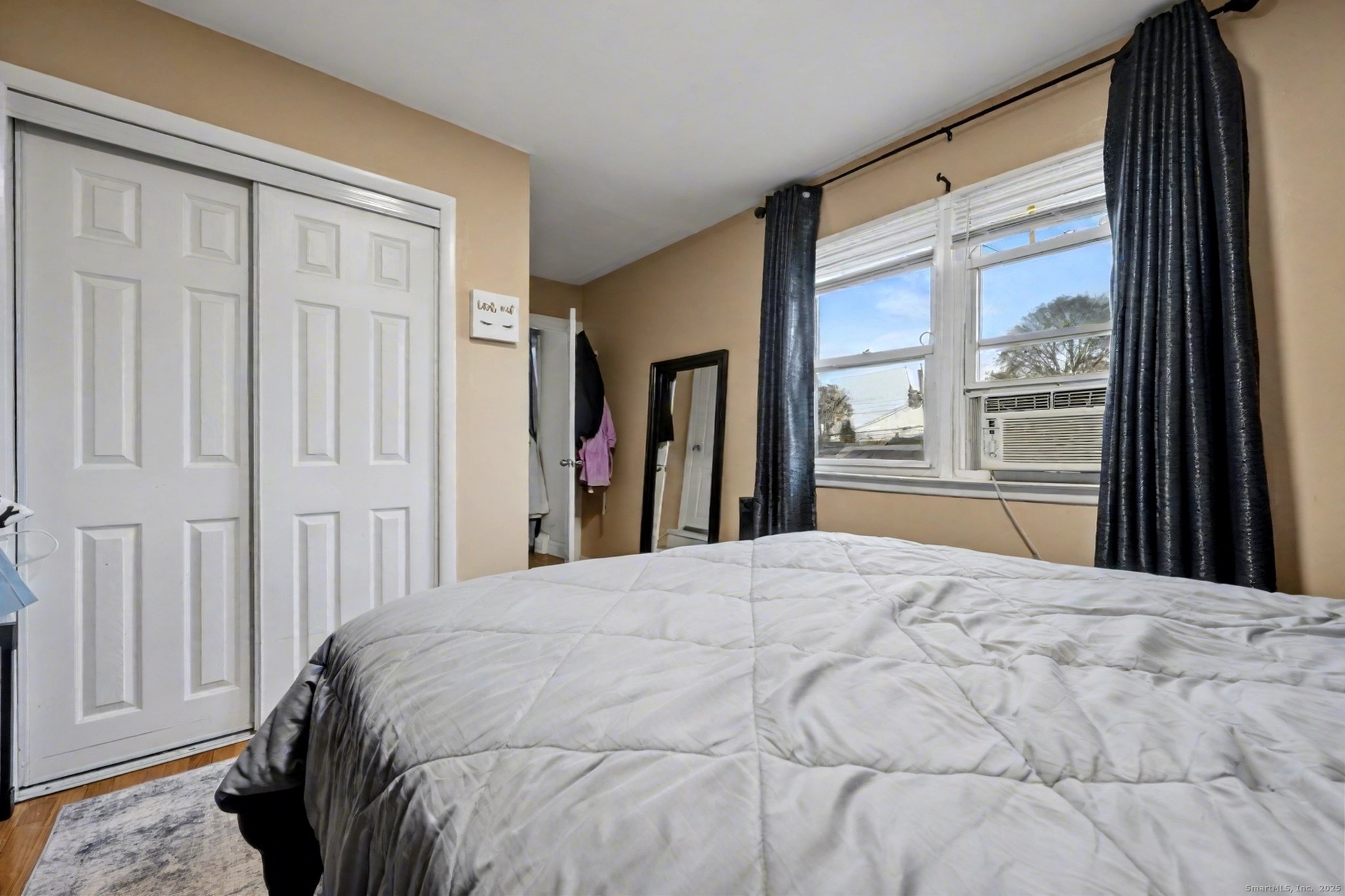 720 Queen Street Bridgeport, CT 06606 - Photo 15 of 36 a bed sitting in a bedroom next to a window