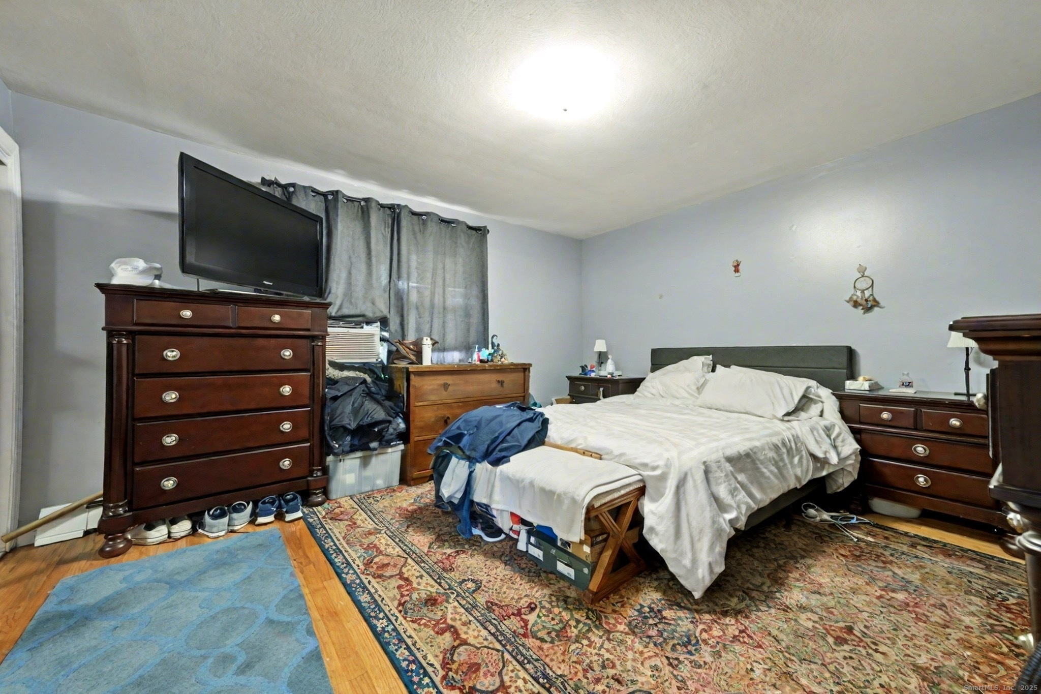 720 Queen Street Bridgeport, CT 06606 - Photo 19 of 36 a bedroom with a bed and a flat screen tv