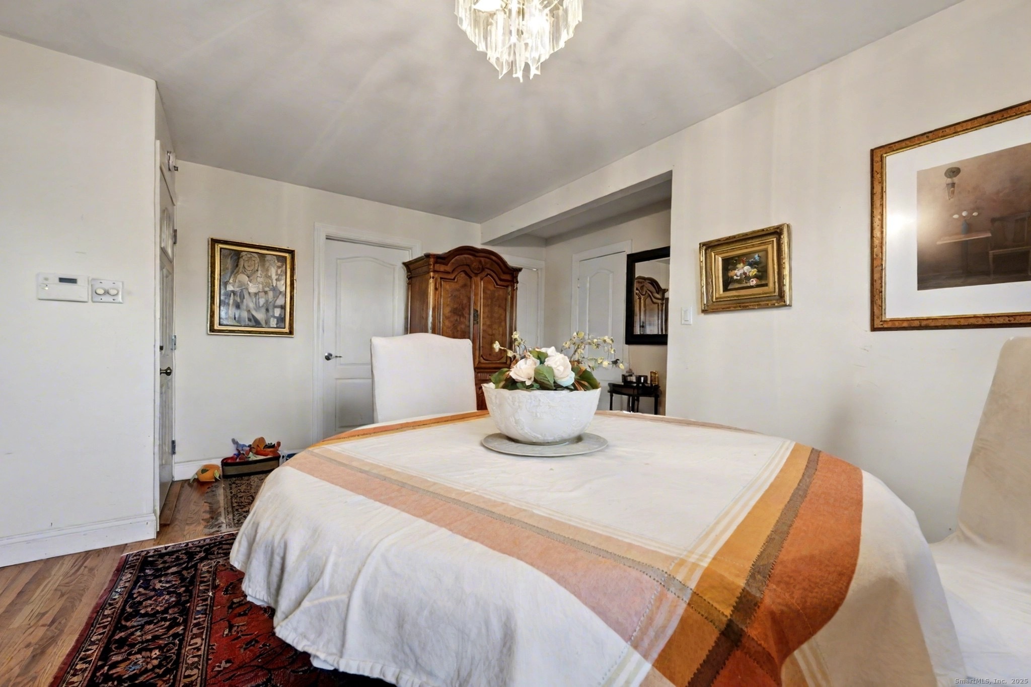 720 Queen Street Bridgeport, CT 06606 - Photo 20 of 36 a bedroom with a bed and a chandelier