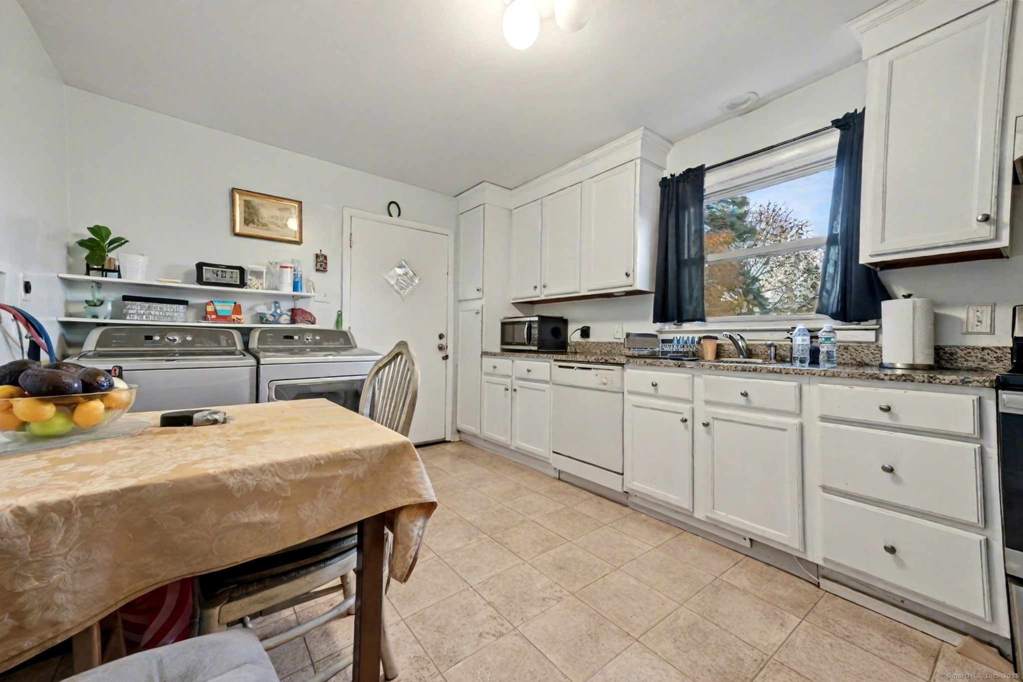 720 Queen Street Bridgeport, CT 06606 - Photo 8 of 36 a kitchen with a table chairs and cabinets