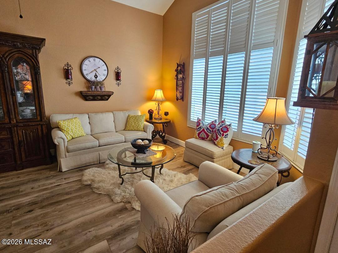 3130 West Star Ranch Trail Tucson, AZ 85742 - Photo 6 of 44 a living room with furniture a fireplace and a large window