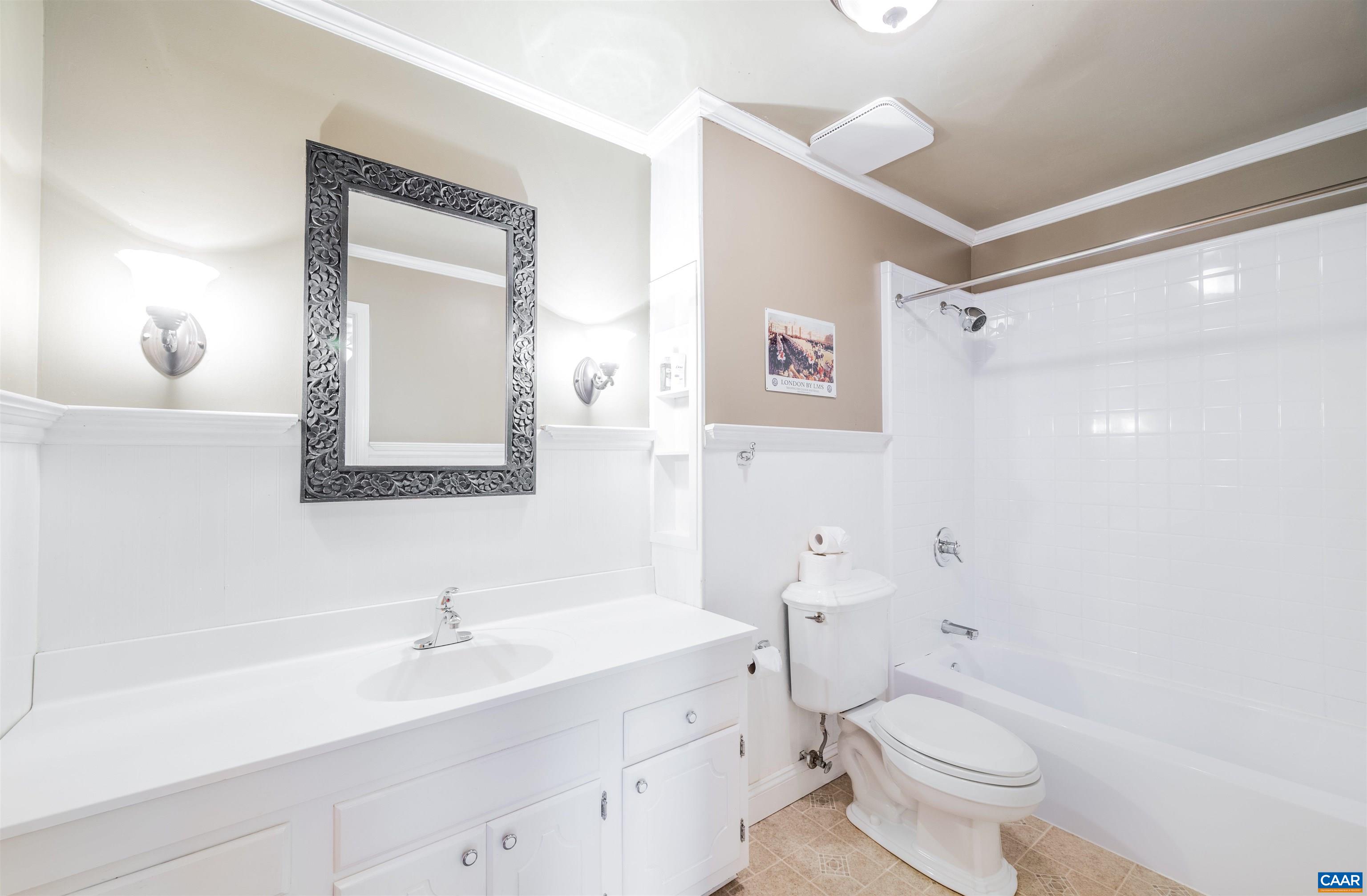 5688 Advance Mills Road Ruckersville, VA 22968 - Photo 7 of 52 a bathroom with a toilet a sink a mirror and a shower