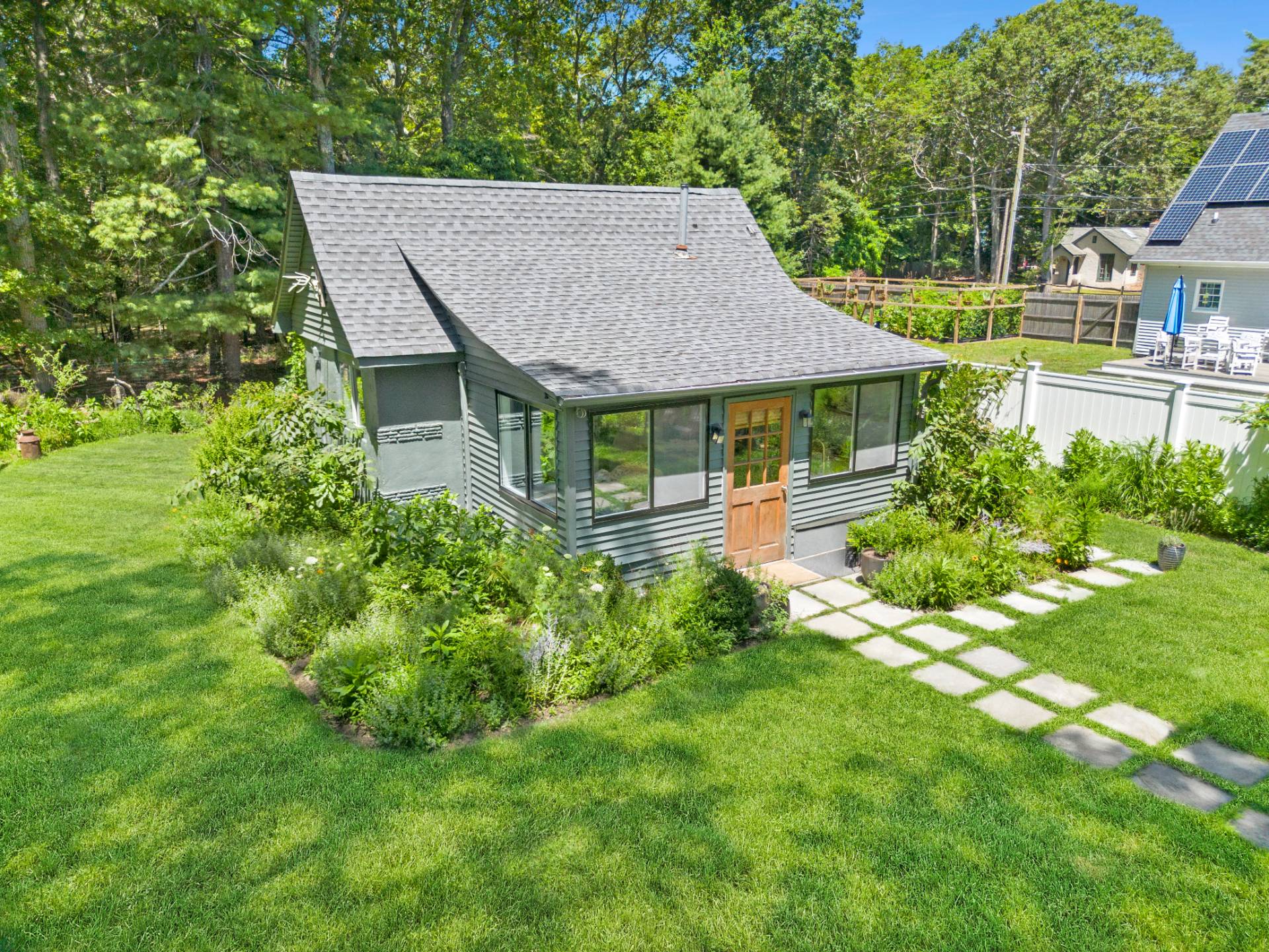 a aerial view of a house next to a big yard and large trees