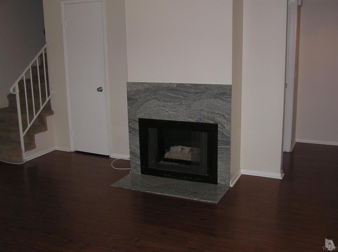 516 Spring Road, Unit 114 Moorpark, CA 93021 - Photo 3 of 13 a living room with a fireplace