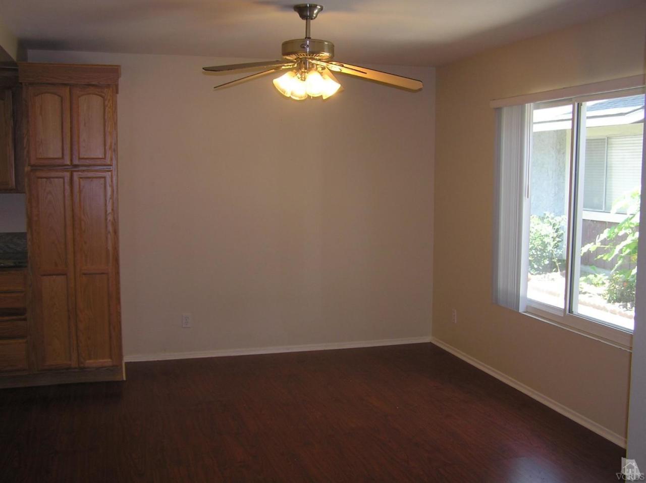 516 Spring Road, Unit 114 Moorpark, CA 93021 - Photo 6 of 13 an empty room with windows and fan