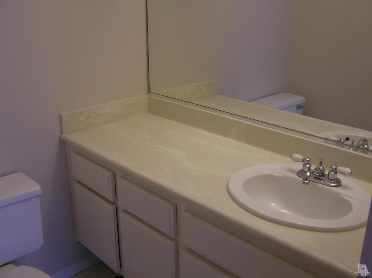 516 Spring Road, Unit 114 Moorpark, CA 93021 - Photo 7 of 13 a bathroom with a sink and a toilet