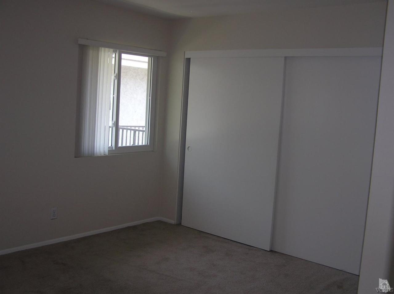 516 Spring Road, Unit 114 Moorpark, CA 93021 - Photo 8 of 13 an empty room with windows