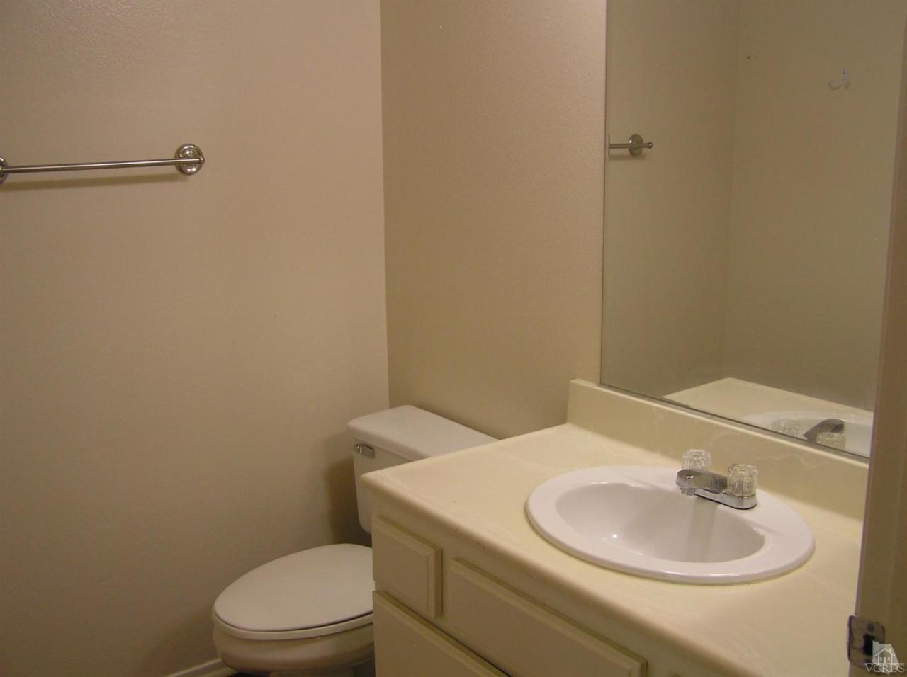 516 Spring Road, Unit 114 Moorpark, CA 93021 - Photo 9 of 13 a bathroom with a sink a toilet and a mirror