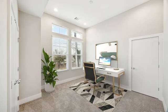 a work room with furniture and a potted plant