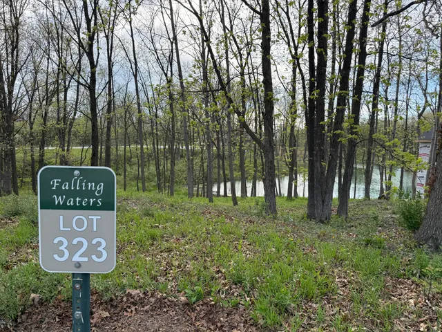 a sign that is sitting on a wooden fence