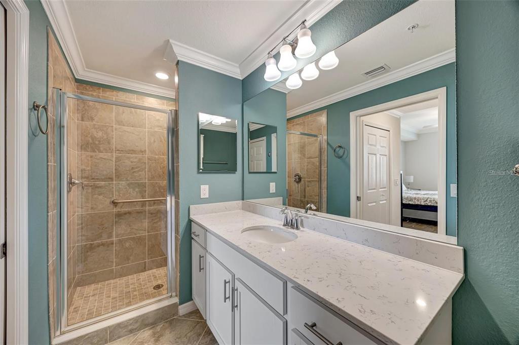 910 Tidewater Shores Loop, Unit 304 Bradenton, FL 34208 - Photo 17 of 42 a bathroom with a sink double vanity and a shower