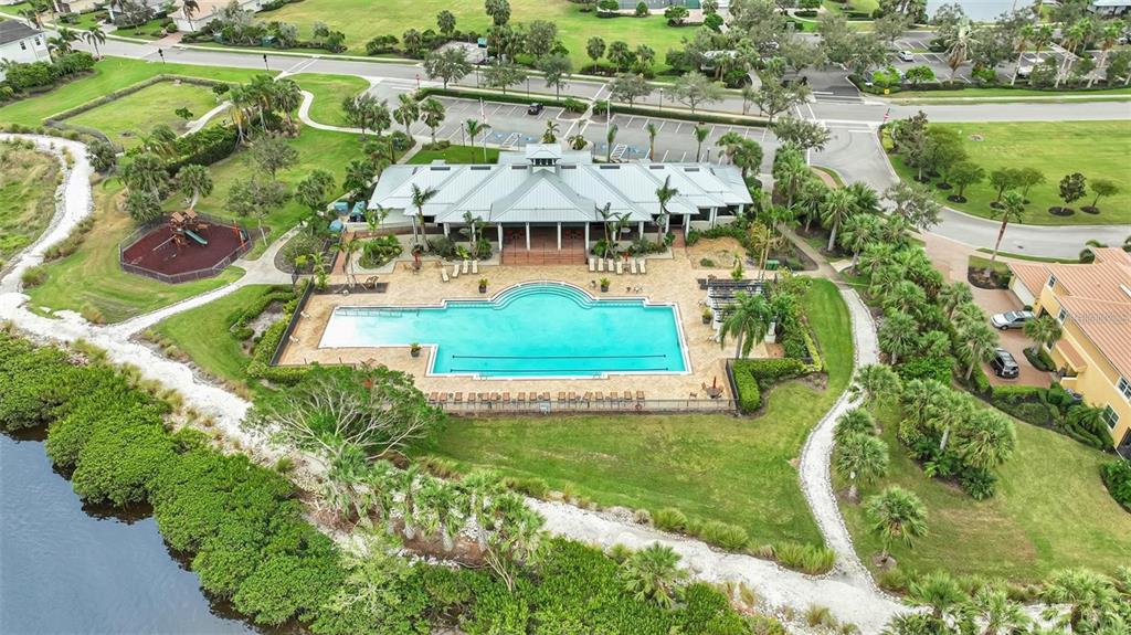 910 Tidewater Shores Loop, Unit 304 Bradenton, FL 34208 - Photo 25 of 42 an aerial view of a house with a yard basket ball court and outdoor seating