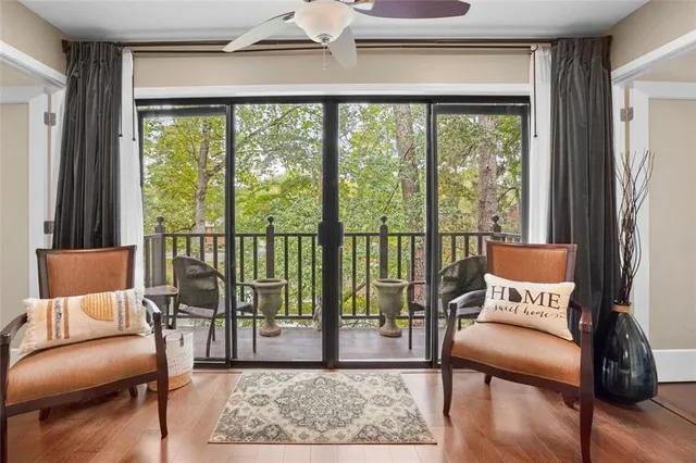 a living room with furniture and a floor to ceiling window