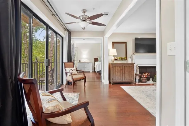 a living room with furniture a fireplace and a flat screen tv