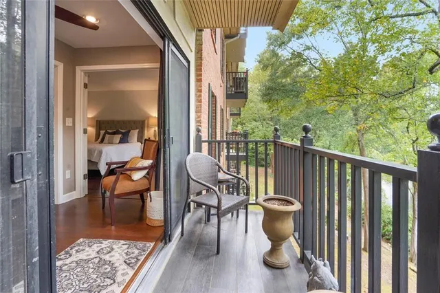 a view of balcony with chairs and wooden fence