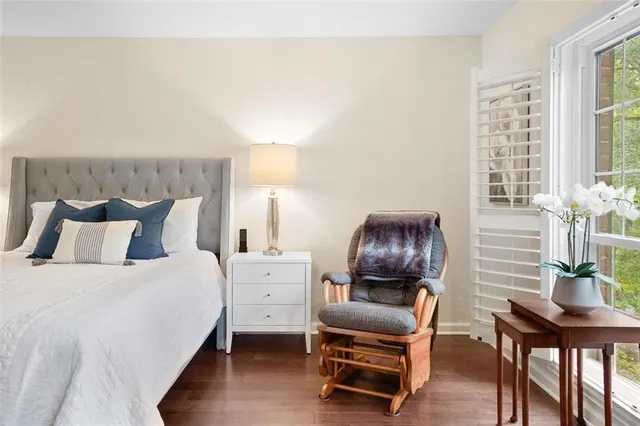 a bedroom with a bed and lounge chair