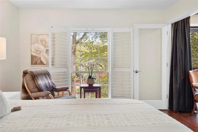 a bedroom with a bed and a chair