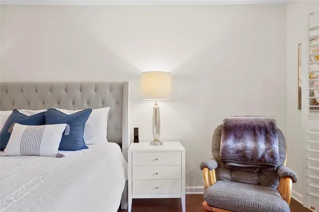 a bedroom with a bed and a lamp