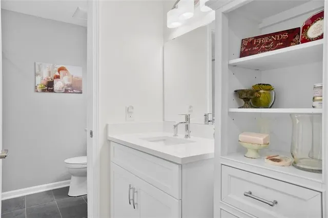 a bathroom with a sink a toilet and a mirror