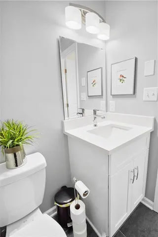 a bathroom with a sink mirror and toilet