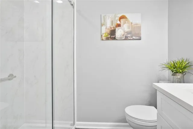 a white toilet sitting next to a shower curtain