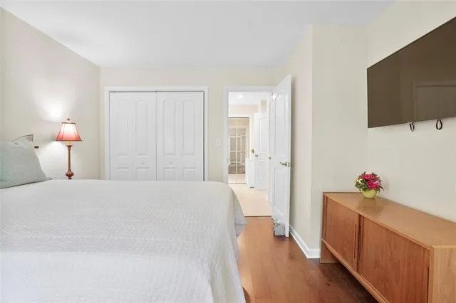 a bedroom with a bed and a flat screen tv