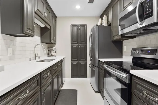 a kitchen with a refrigerator sink and microwave