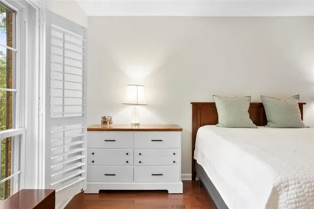 a bedroom with bed and window