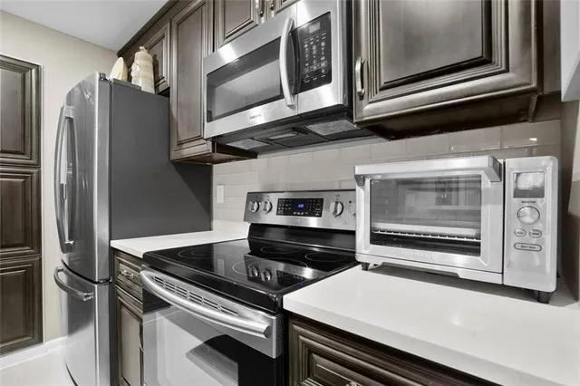a kitchen with stainless steel appliances and cabinets