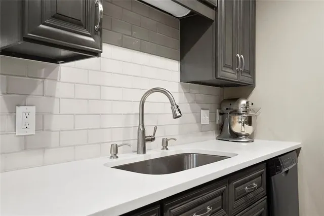 a kitchen with a sink and cabinets