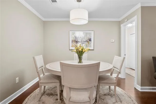 a dining room with furniture and wooden floor