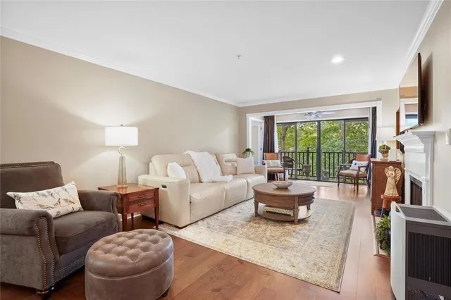 a living room with furniture a large window and a flat screen tv