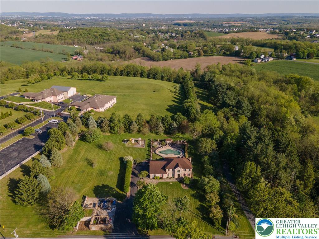 2170 Clearview Road Coplay, PA 18037 - Photo 9 of 75 Perched on an expansive lot, this grand residence offers a private pool and a picturesque backdrop of rolling hills.