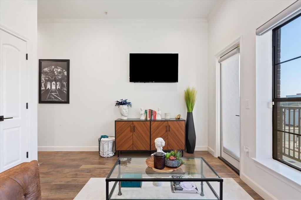 330 Austin Avenue, Unit 318 Waco, TX 76701 - Photo 12 of 22 Living area with dark wood-type flooring and baseboards