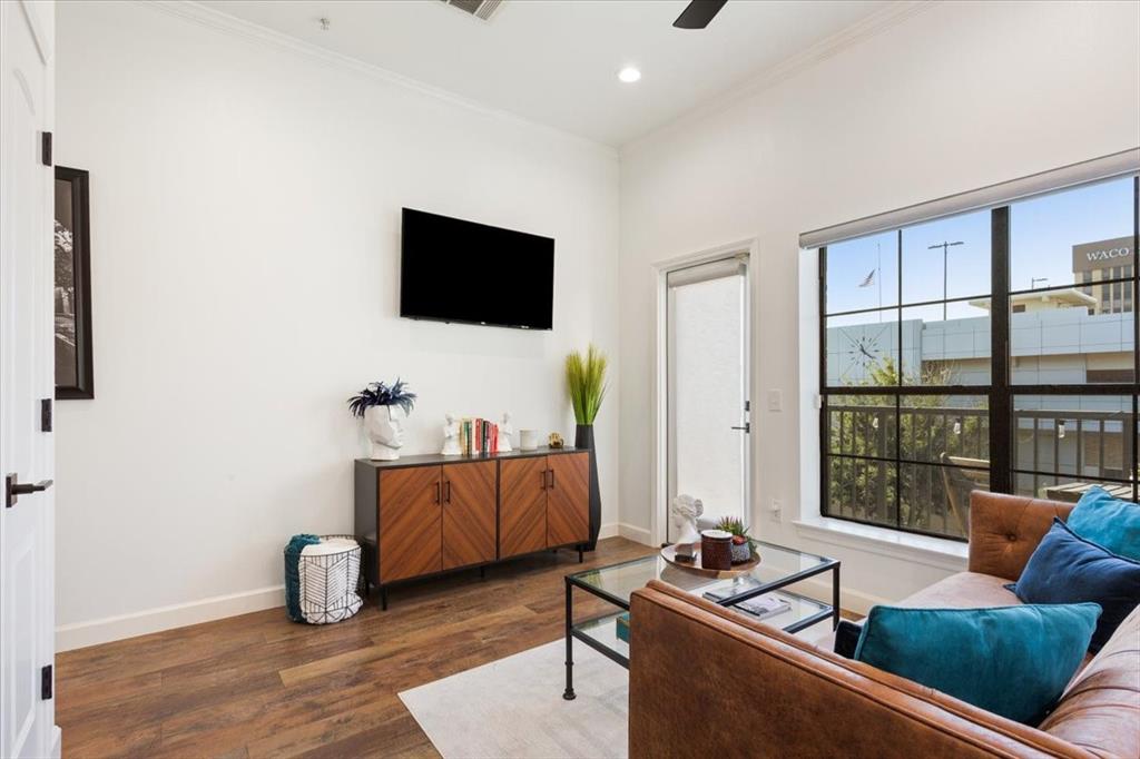 330 Austin Avenue, Unit 318 Waco, TX 76701 - Photo 13 of 22 Living area featuring crown molding, dark wood-type flooring, recessed lighting, and a ceiling fan