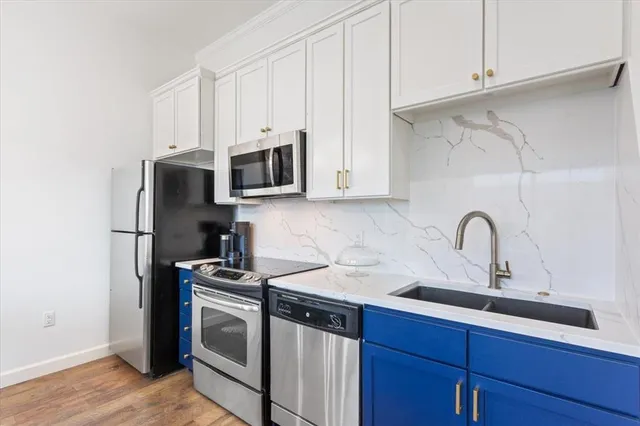 a kitchen with stainless steel appliances granite countertop white cabinets a sink and dishwasher