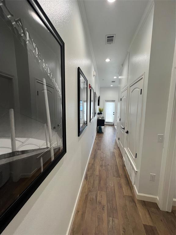 330 Austin Avenue, Unit 318 Waco, TX 76701 - Photo 4 of 22 Hall featuring dark wood-type flooring, recessed lighting, and ornamental molding