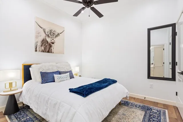 a bedroom with a bed and painting on the wall