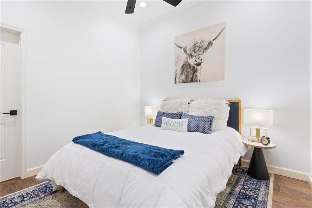 330 Austin Avenue, Unit 318 Waco, TX 76701 - Photo 6 of 22 Bedroom featuring wood finished floors, ornamental molding, and a ceiling fan