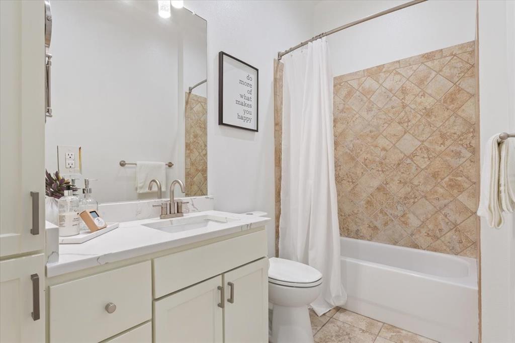 330 Austin Avenue, Unit 318 Waco, TX 76701 - Photo 7 of 22 Bathroom featuring vanity, shower / tub combo, and light tile patterned flooring