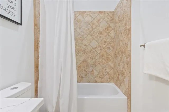 a bathroom with a bathtub and shower