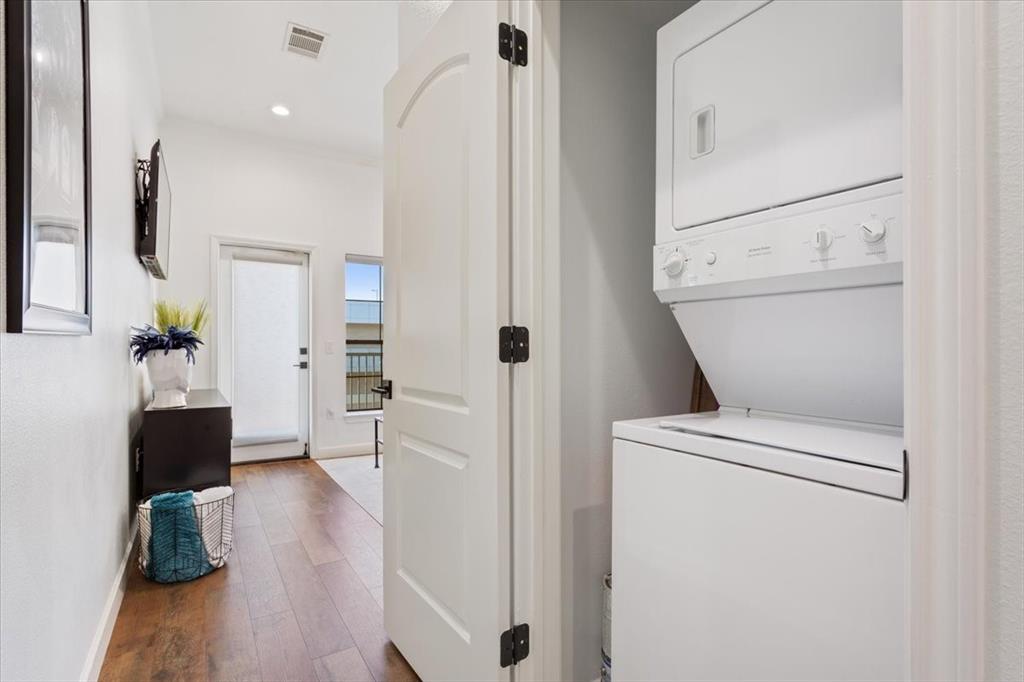 330 Austin Avenue, Unit 318 Waco, TX 76701 - Photo 10 of 22 Laundry area featuring dark wood-style floors, stacked washing machine and dryer, and recessed lighting