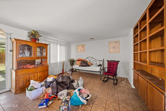 a living room with furniture a rug and a window