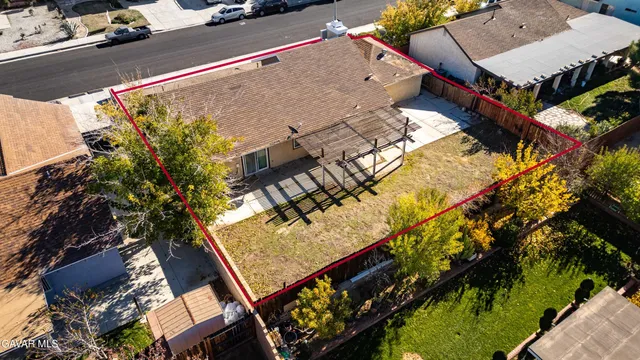 an aerial view of a house with a yard and sitting area