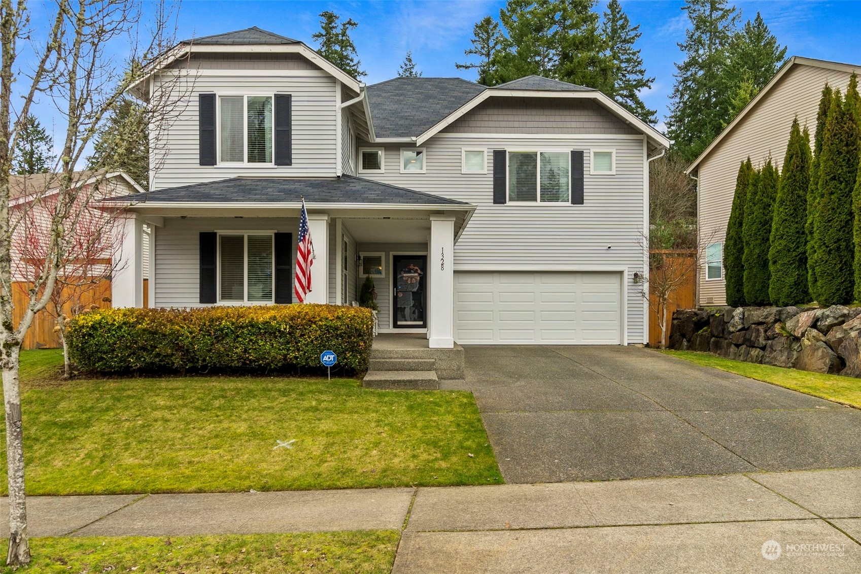 1328 Foreman Road DuPont, WA 98327 - Photo 1 of 37 a front view of a house with a yard and garage