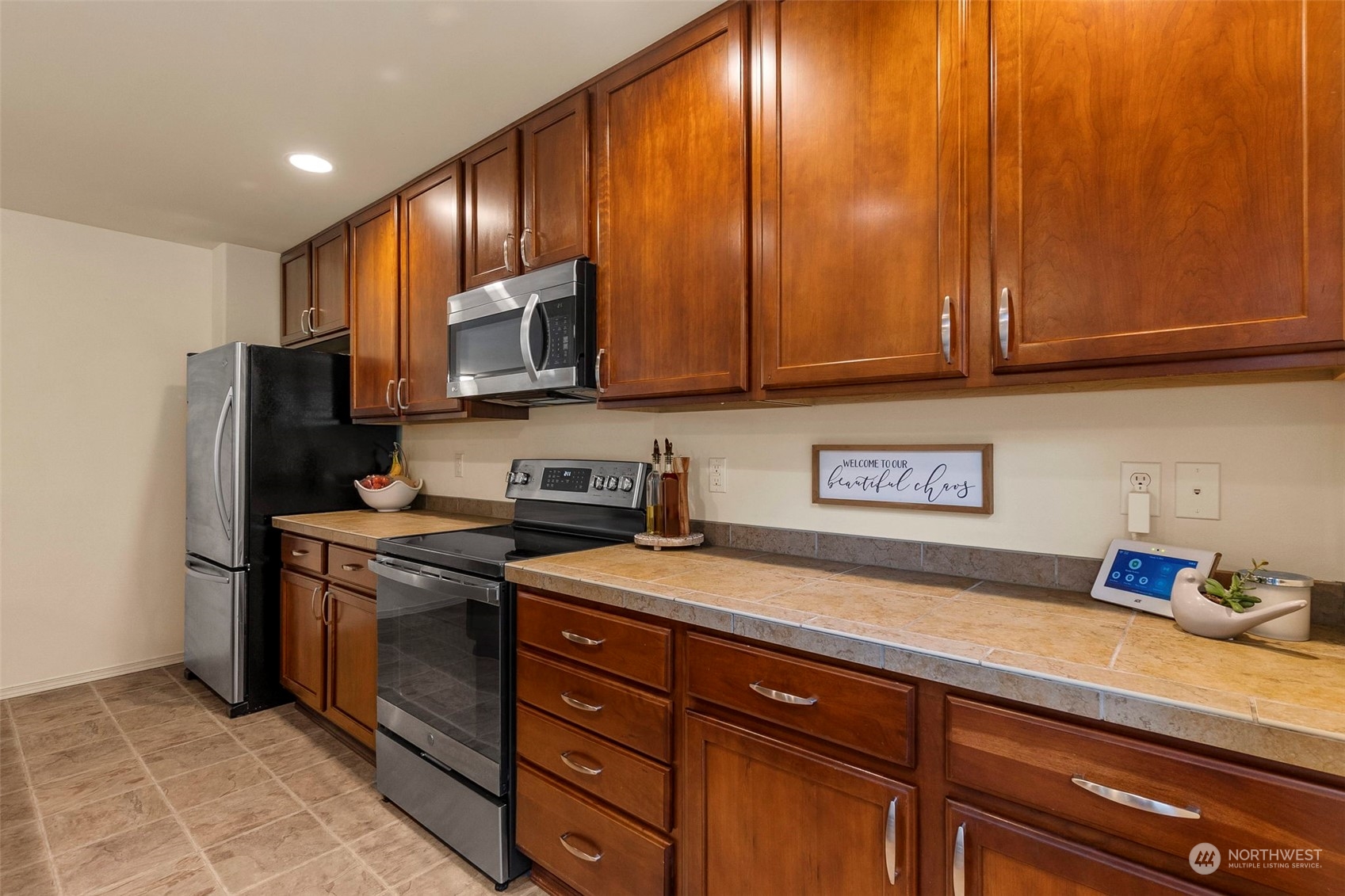 1328 Foreman Road DuPont, WA 98327 - Photo 14 of 37 a kitchen with stainless steel appliances granite countertop wood cabinets a refrigerator and a sink