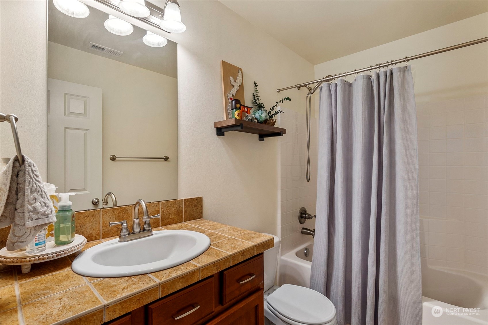 1328 Foreman Road DuPont, WA 98327 - Photo 16 of 37 a bathroom with a granite countertop sink toilet and a mirror