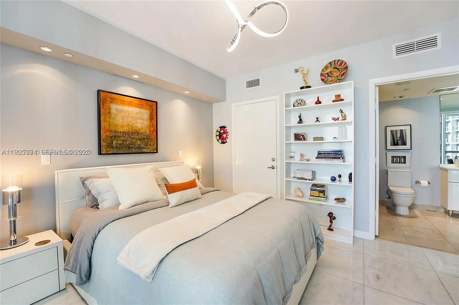 495 Brickell Avenue, Unit 3304 Miami, FL 33131 - Photo 18 of 28 a bedroom with a bed and a window