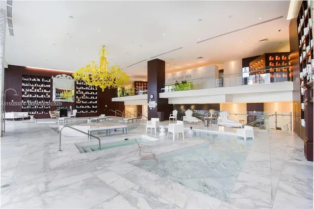 a living room with fireplace furniture and a large window