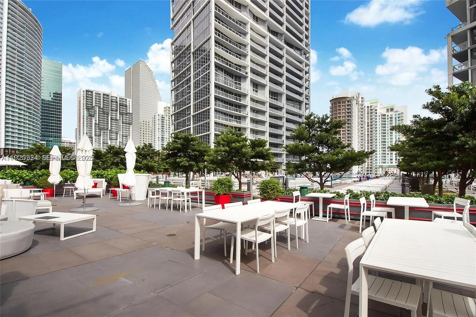 495 Brickell Avenue, Unit 3304 Miami, FL 33131 - Photo 23 of 28 a view of a patio with dining table and chairs